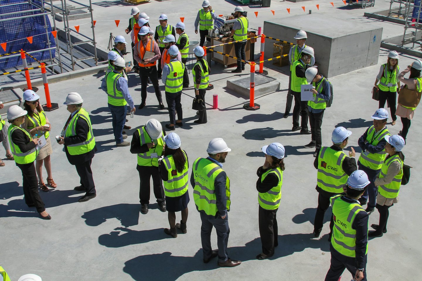 Construction workers in hard hats holding a meeting on site.